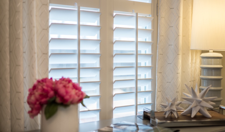 Plantation shutters by flowers in Hartford